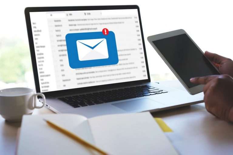 email popup on laptop screen while user opens cell phone