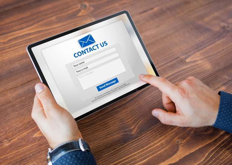 person filling out an online contact form on an ipad