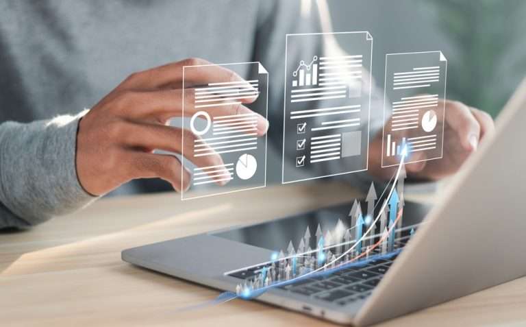 person using laptop with holographic images