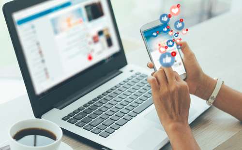 social media likes on phone and laptop