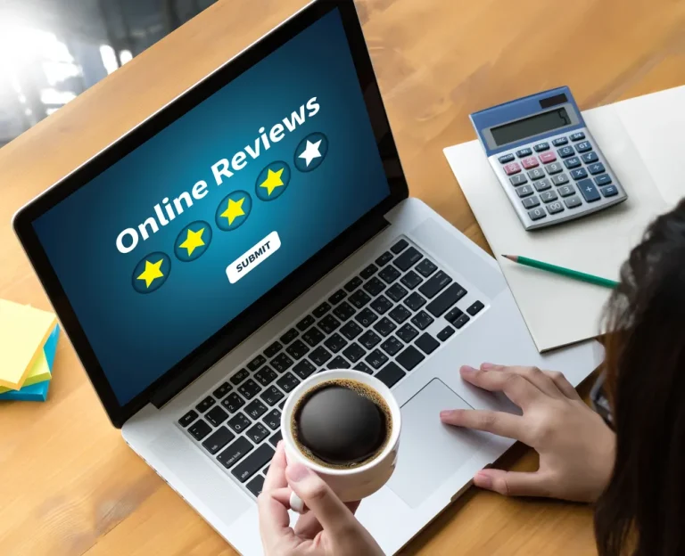 Online reviews pictured on a laptop with coffee cup nearby